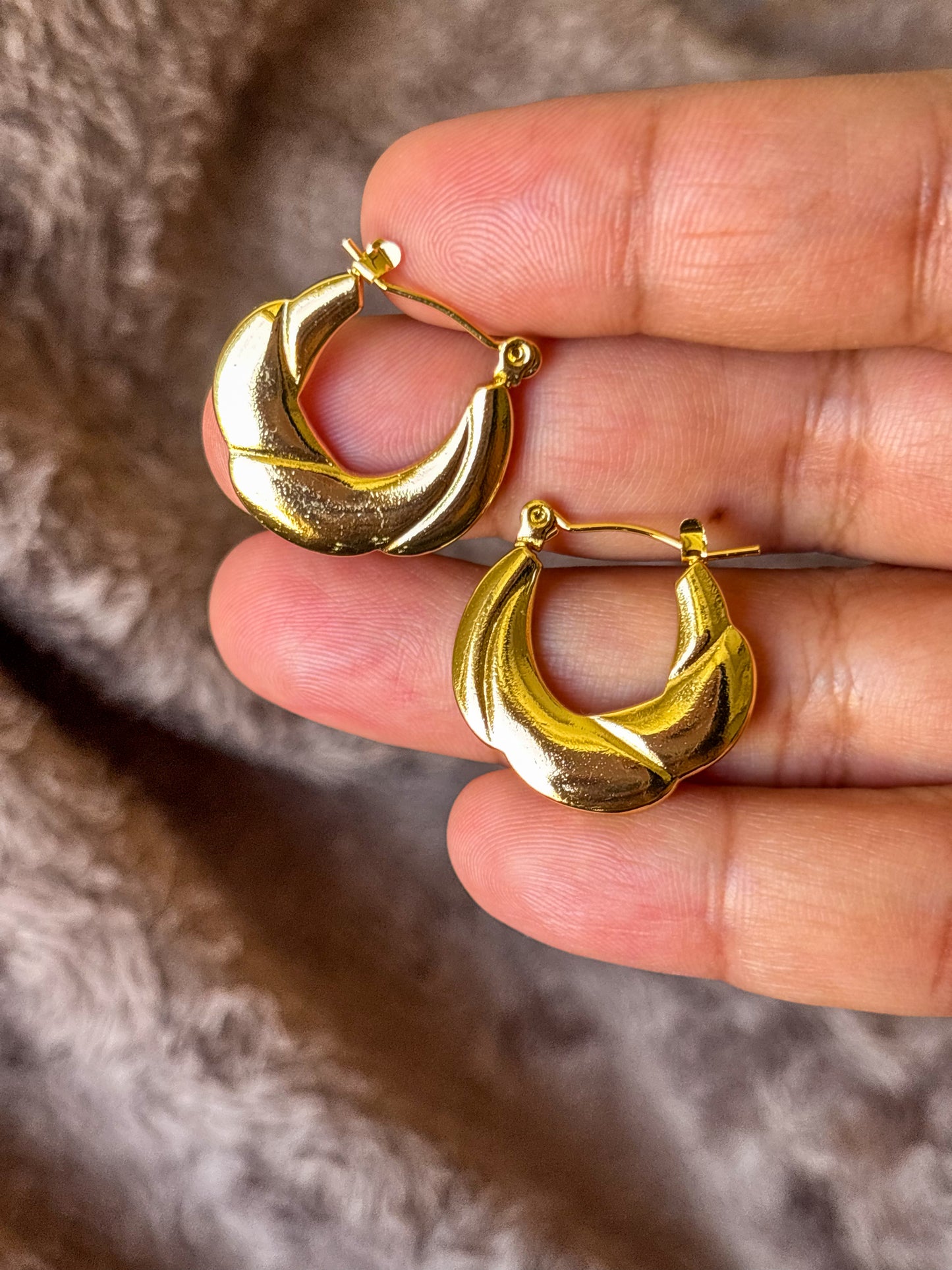 Anti-tarnish sculpted gold hoop earrings with a bold textured design, displayed with natural lighting for a luxurious, minimalist look.
