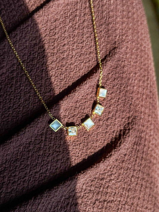 Dainty gold necklace with square gemstone charms in a minimalist anti-tarnish design