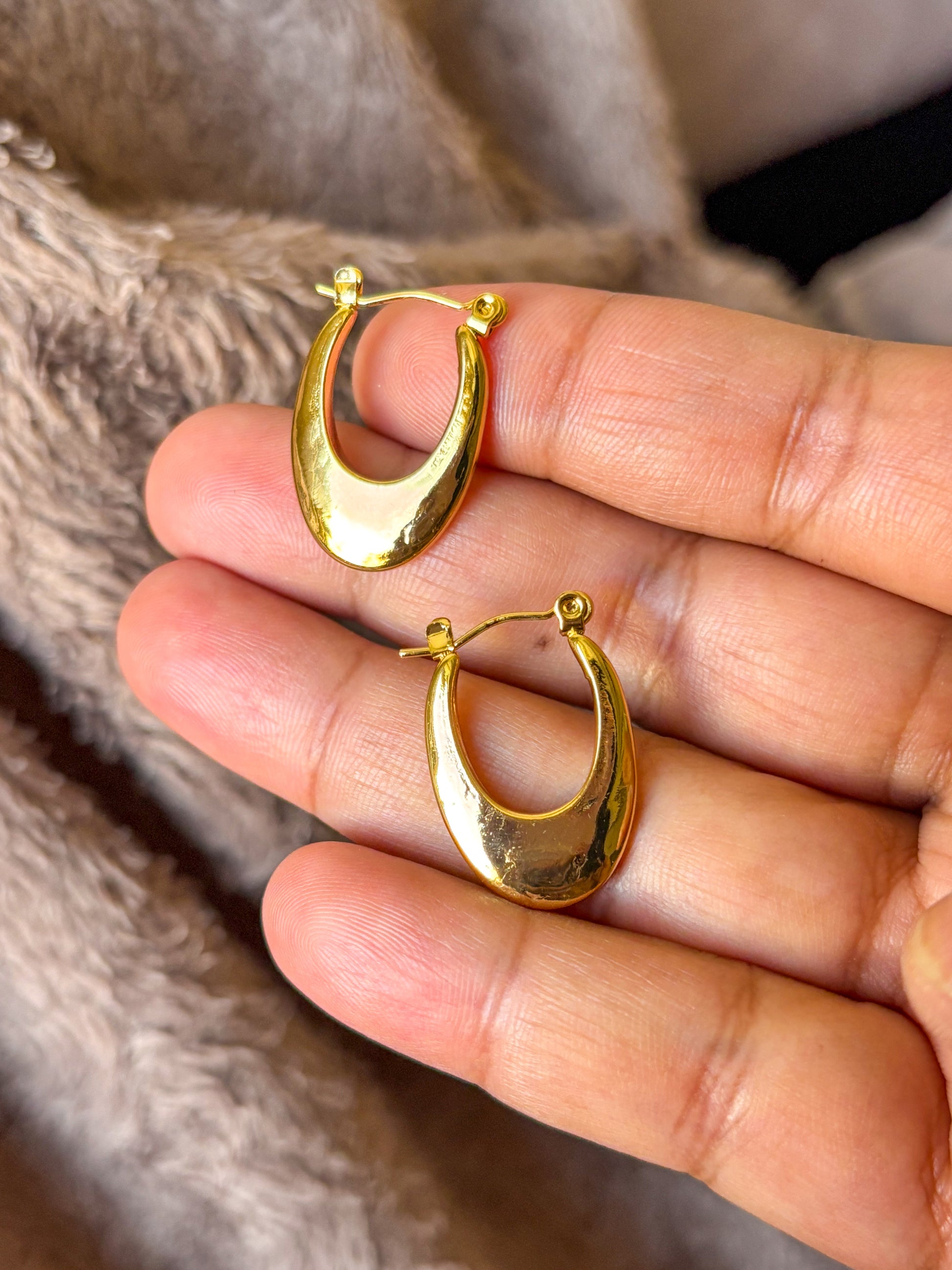 Elegant anti-tarnish gold teardrop hoop earrings with a sleek polished finish, on an aesthetic background. Lightweight, waterproof statement hoops perfect for everyday wear and special occasions.