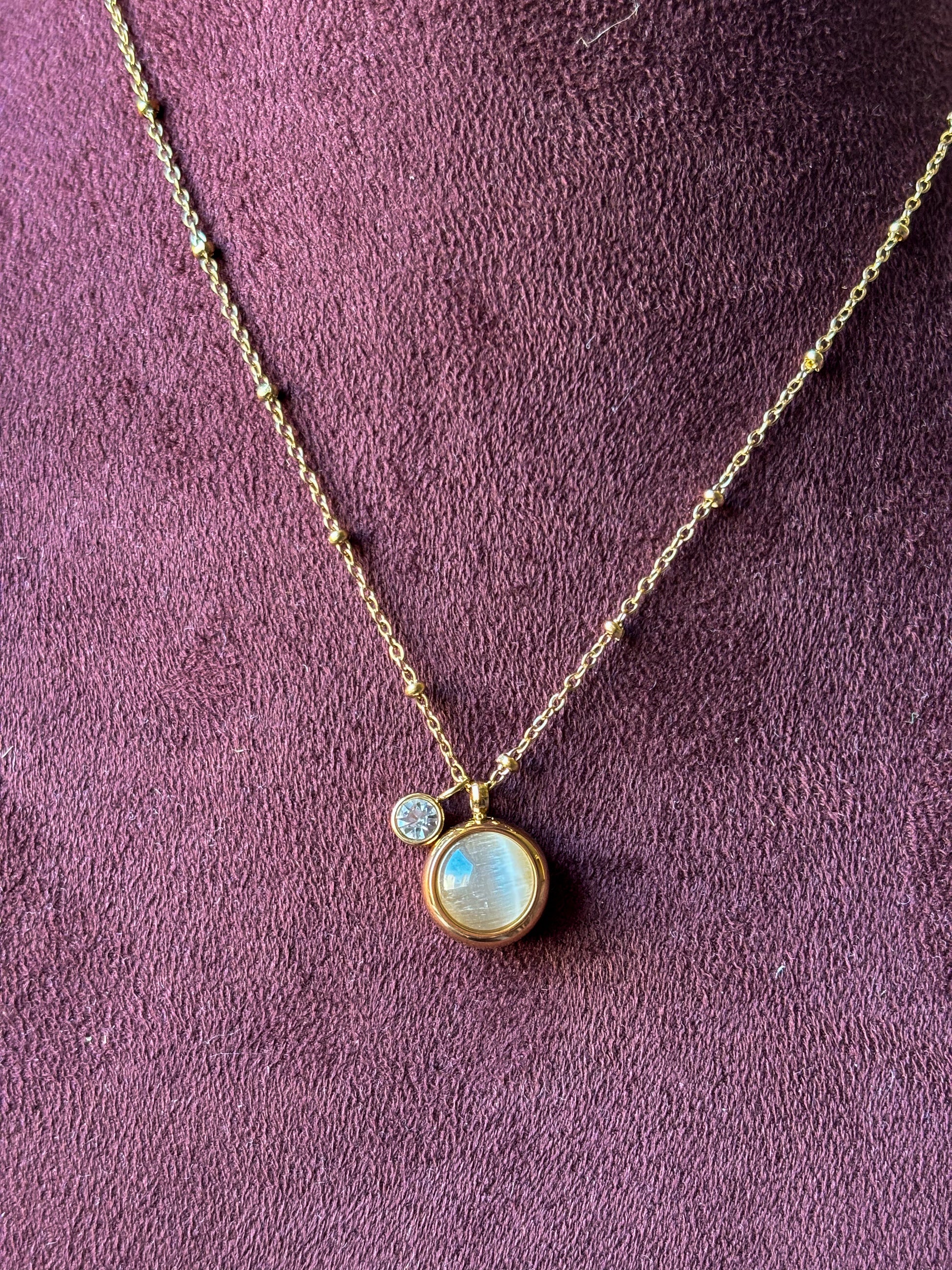 Elegant gold pendant necklace with a pearl-inspired charm and crystal accent. Minimal, anti-tarnish jewellery perfect for everyday wear and layering.