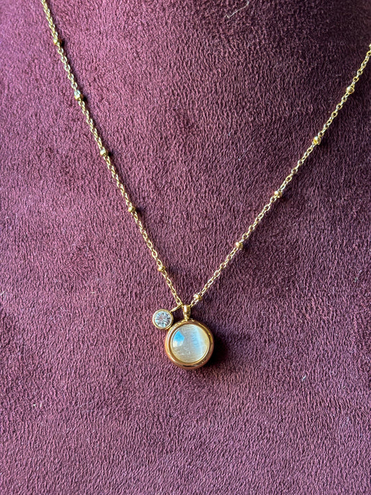 Elegant gold pendant necklace with a pearl-inspired charm and crystal accent. Minimal, anti-tarnish jewellery perfect for everyday wear and layering.