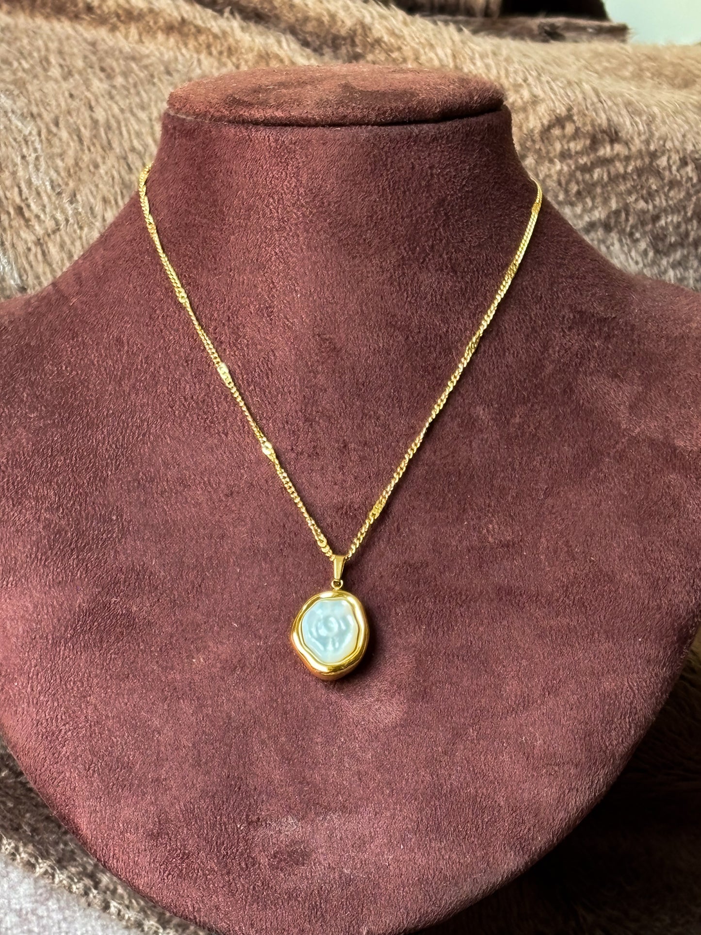 Elevate your everyday style with this gold-tone pearl pendant necklace, featuring a luminous pearl-inspired centerpiece and a textured chain