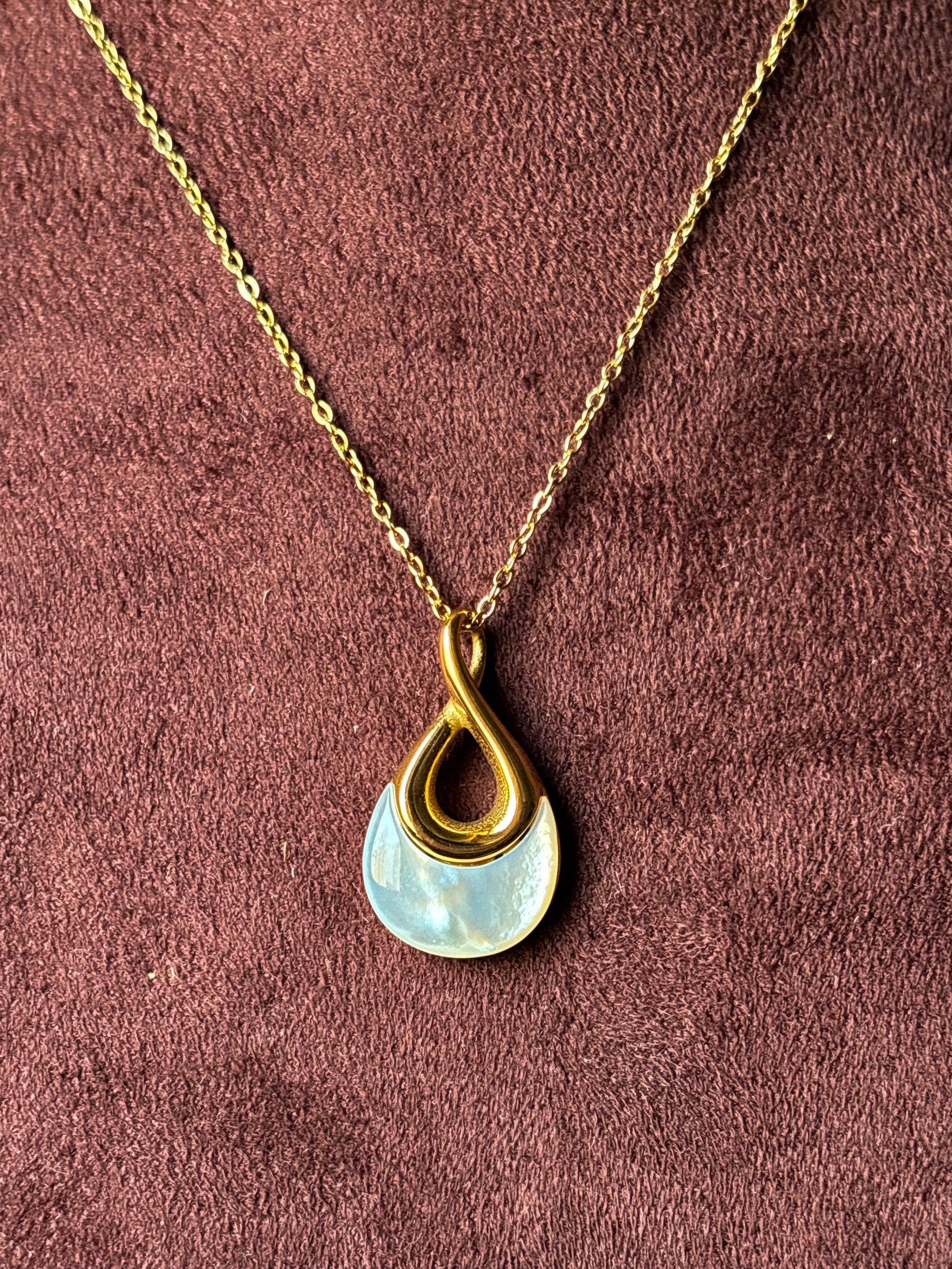 Elegant gold anti-tarnish necklace with a modern teardrop pendant featuring a pearl-inspired detail.
