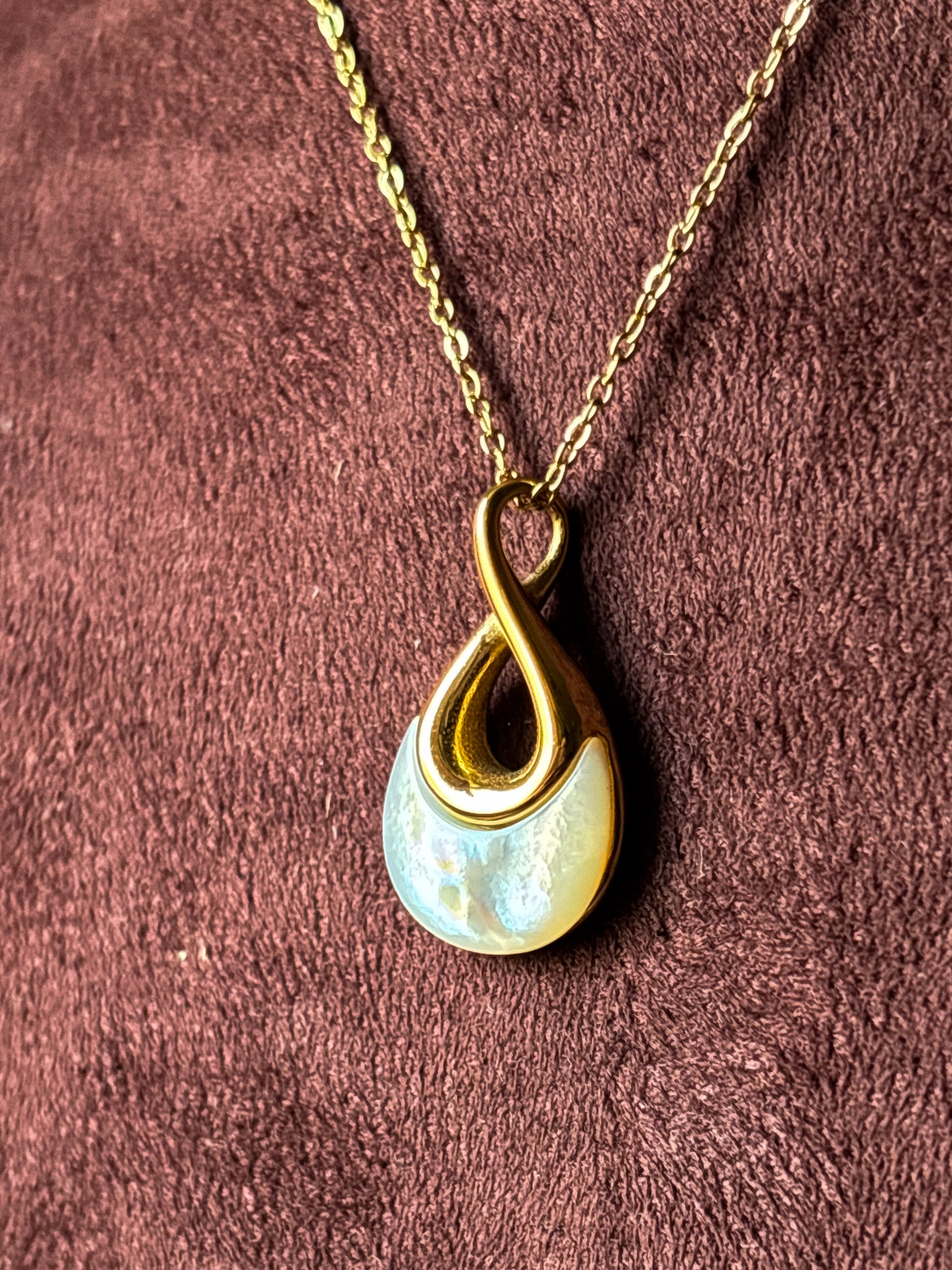 Elegant gold anti-tarnish necklace with a modern teardrop pendant featuring a pearl-inspired detail.