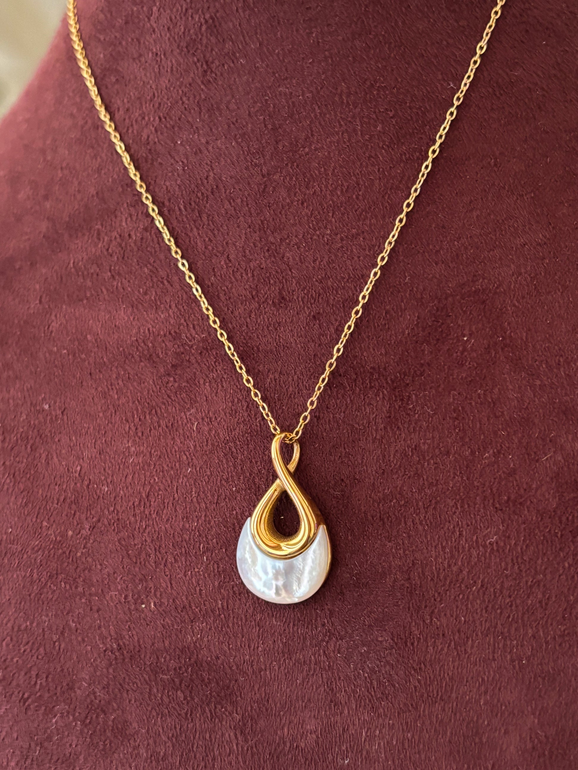 Elegant gold anti-tarnish necklace with a modern teardrop pendant featuring a pearl-inspired detail.