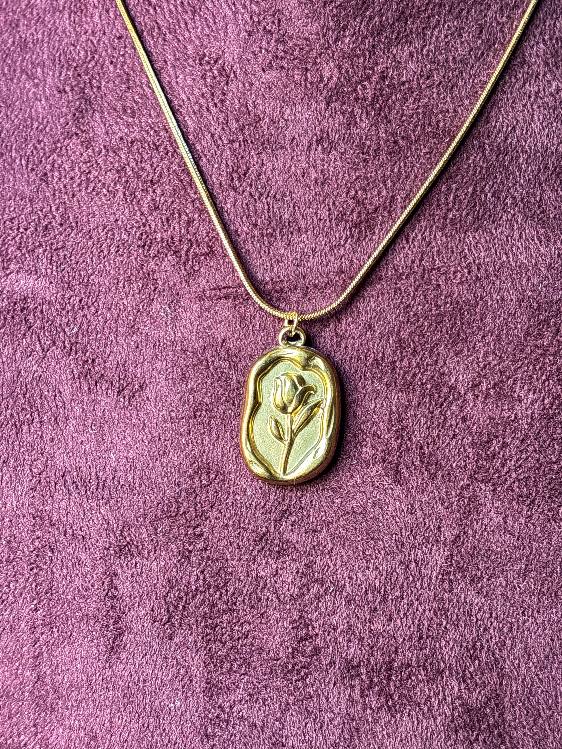 Elegant anti-tarnish gold-tone rose pendant necklace featuring a floral engraved rectangular charm on a sleek snake chain.Perfect for everyday wear, gifting, and minimalist jewellery styling.