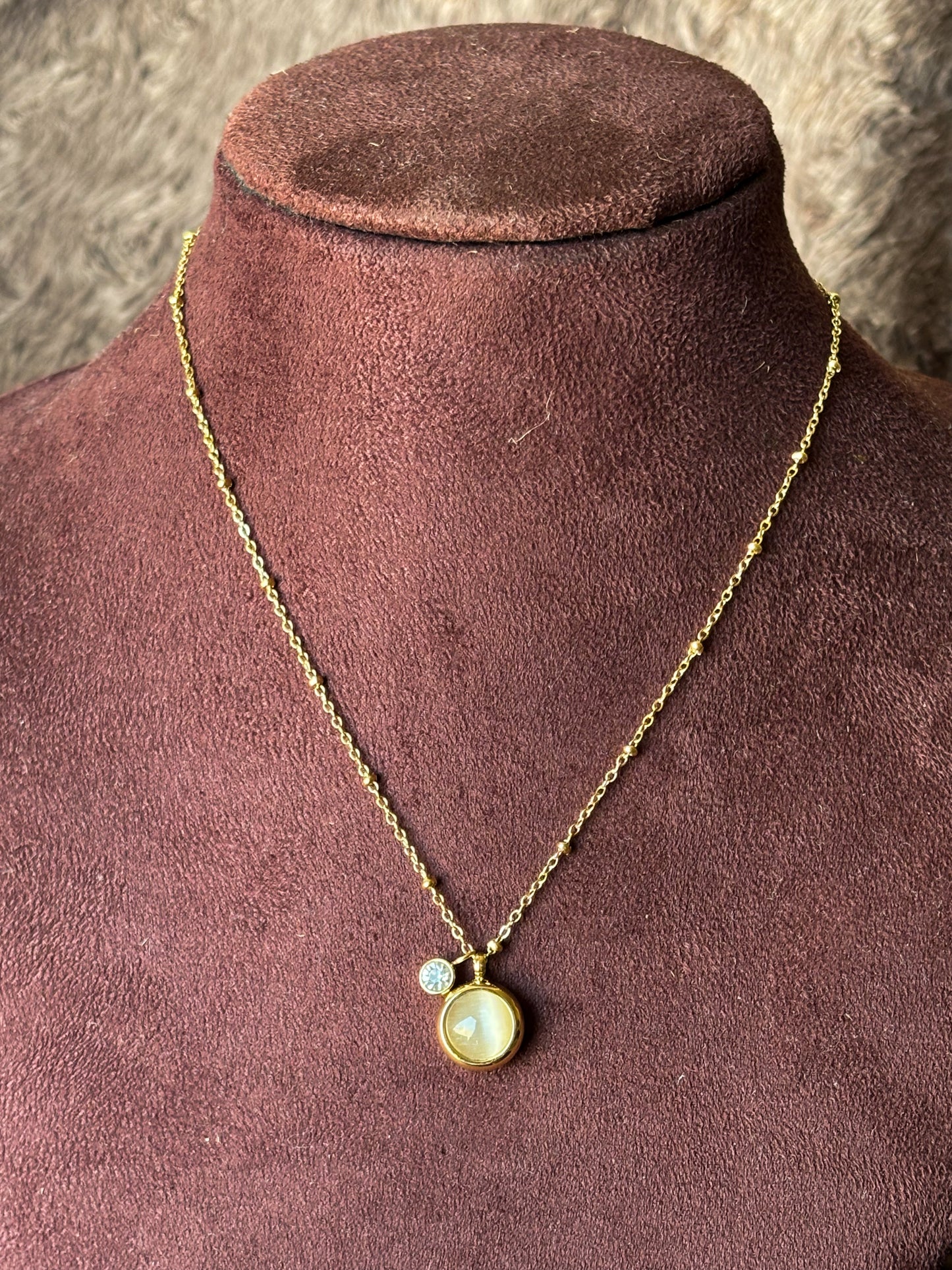 Elegant gold pendant necklace with a pearl-inspired charm and crystal accent. Minimal, anti-tarnish jewellery perfect for everyday wear and layering.