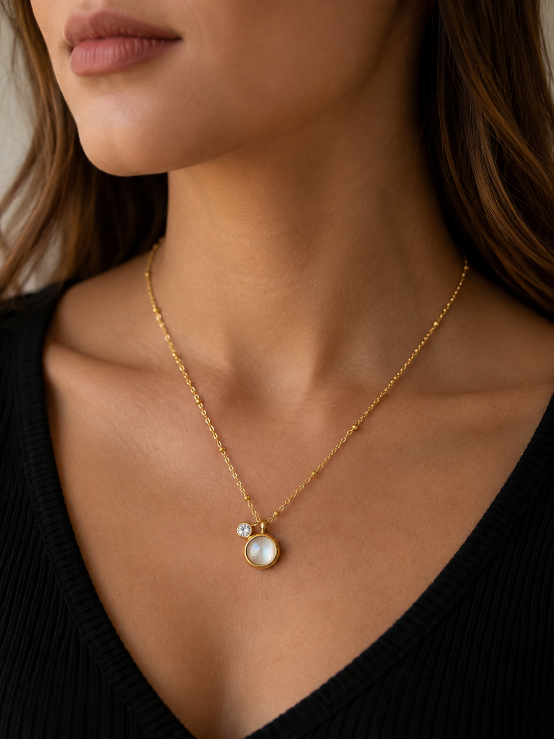 Elegant gold pendant necklace with a pearl-inspired charm and crystal accent. Minimal, anti-tarnish jewellery perfect for everyday wear and layering.