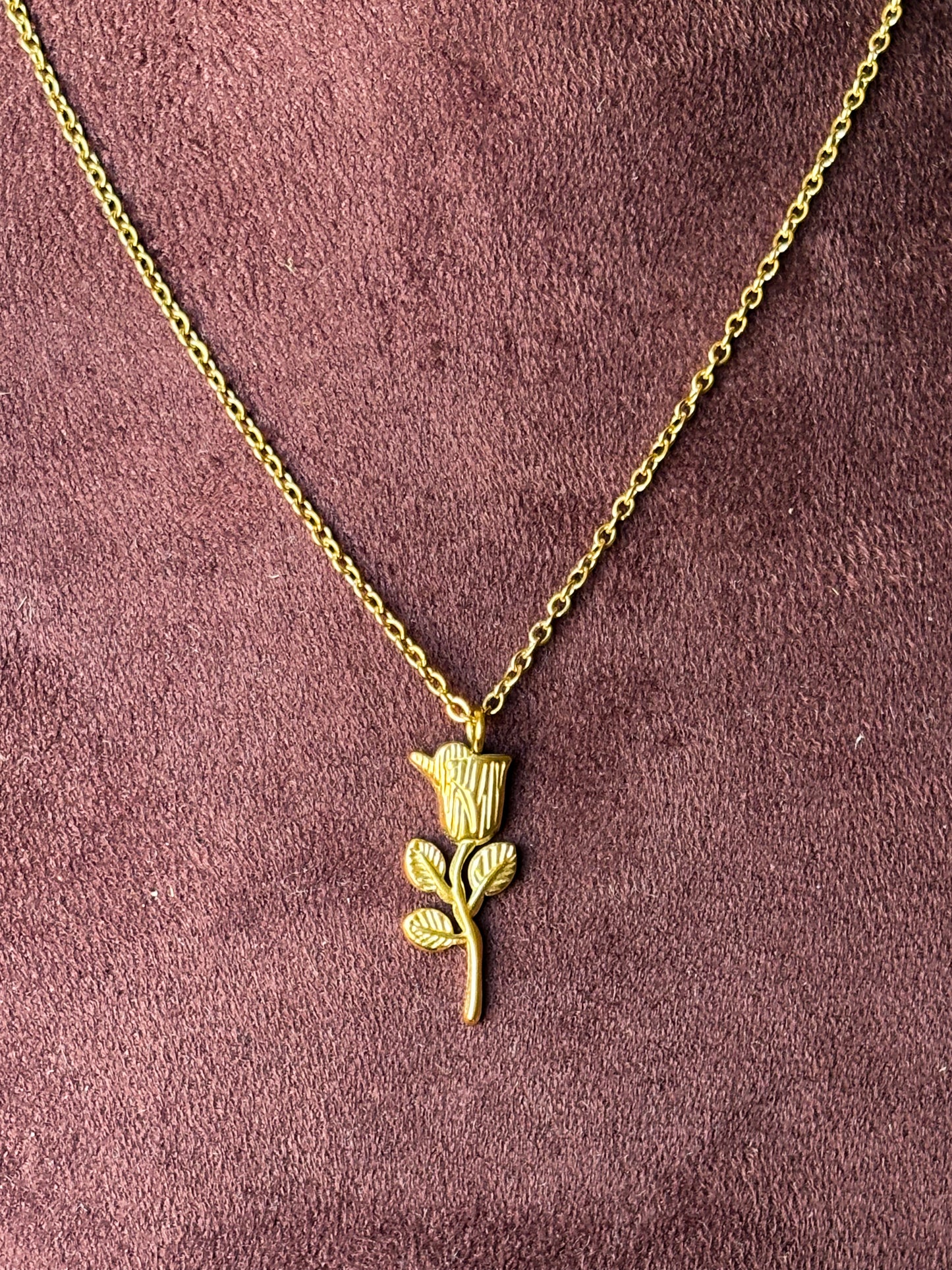 Gold necklace with a rose pendant 