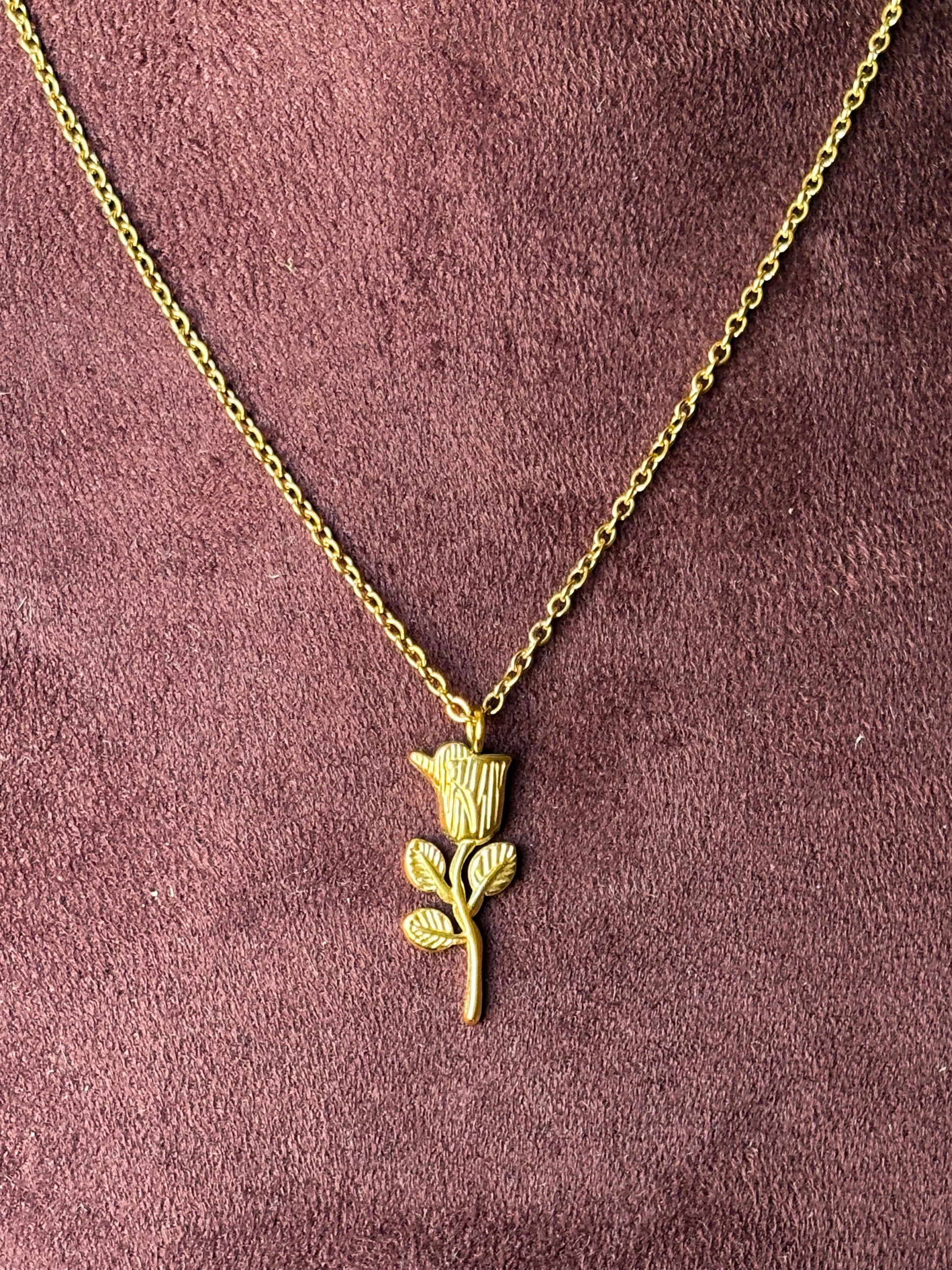 Gold necklace with a rose pendant 