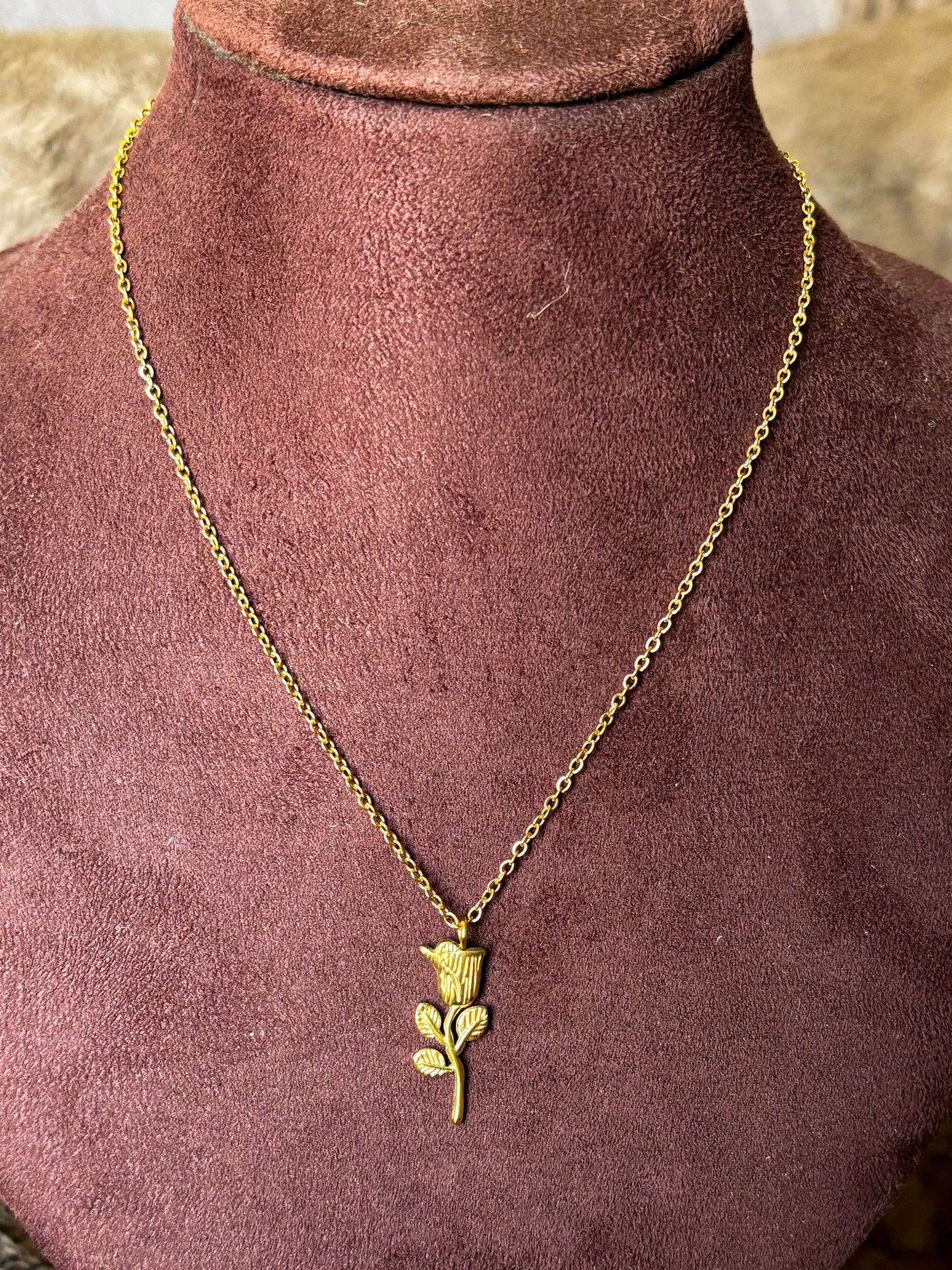 Gold necklace with a rose pendant 