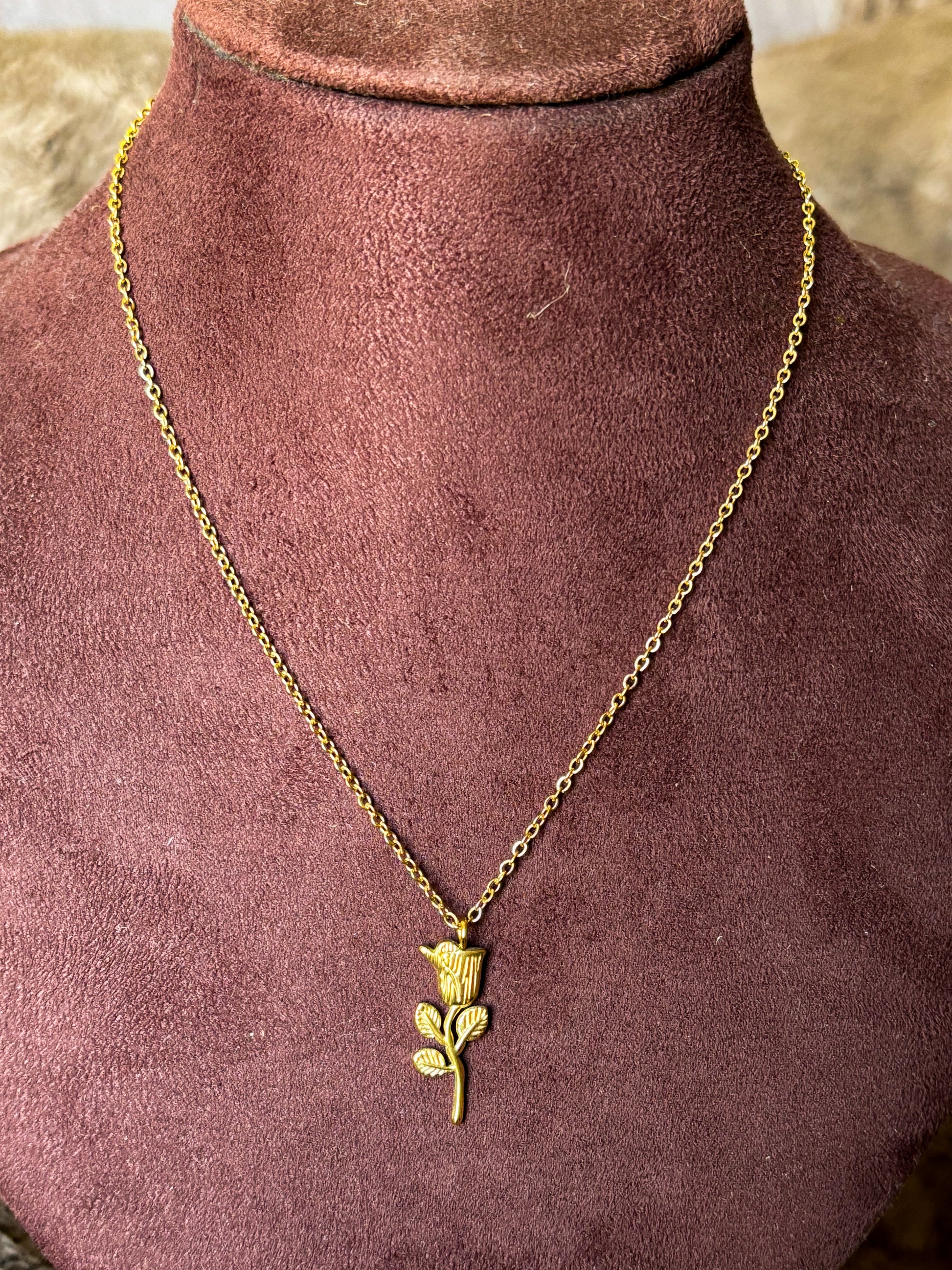 Gold necklace with a rose pendant 