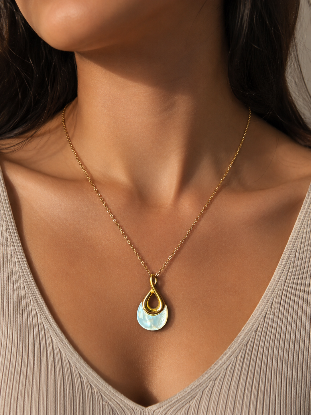 Elegant gold anti-tarnish necklace with a modern teardrop pendant featuring a pearl-inspired detail.